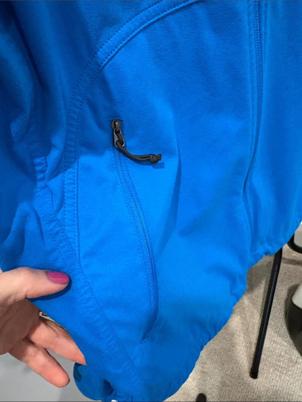 The North Face men’s Blue Jacket with Black Chest Panel and many pockets